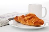 Answer breakfast,croissant,daily newspaper